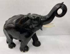 An early to mid 20th Century carved treenware and ebonised elephant figure of large proportions