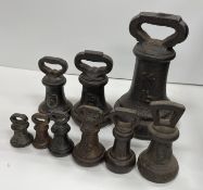 A composite set of nine cast iron bell weights including 14 lb, 4 lb, 2 lb x 2, 1 lb x 2,