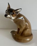 A Royal Doulton figure of a seated fox (HN 130), 22.