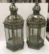A pair of modern metal and glass decorative hanging lanterns of hexagonal form with stylised crown