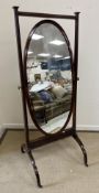 An Edwardian mahogany and inlaid cheval mirror with brass urn finials raised on splayed square