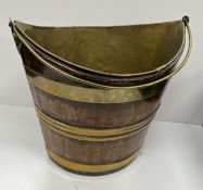 A 19th Century brass bound coopered bucket of navette form with swing handle,