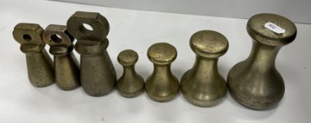A set of four brass bell weights 7 lb, 4 lb,