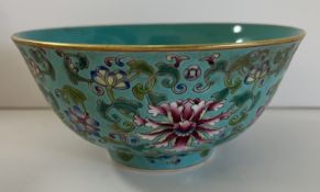 A Chinese turquoise ground rice bowl with plain interior and gilt rim,