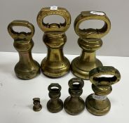 A composite set of seven imperial brass bell weights including 4 lb x 2, 2 lb, 1 lb, 8 oz,