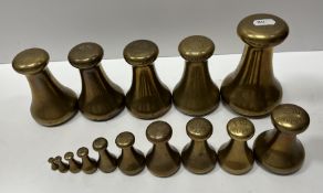 A collection of fifteen Avery brass imperial bell weights including 7 lb, 4 lb x 4, 2 lb, 1 lb x 3,