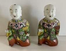 A pair of 19th Century Chinese polychrome decorated spill vases as kneeling figures in floral