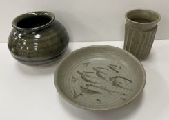 A Katherine Pleydell Bouverie part green glazed ribbed vase with flared rim on a shallow circular