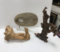 A carved wooden stone style 'Dashburn' sculpture attributed to Ashley Home Accents on a perspex