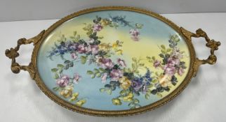 A Limoges porcelain tray with gilt metal mounts, the centre field decorated with floral spray,