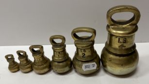 A set of six graduated imperial brass bell weights 4 lb, 2 lb, 1 lb, 8 oz,