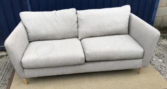 A modern grey upholstered two seat sofa