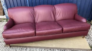 A modern burgundy leather upholstered th