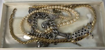A white metal charm bracelet, the clasp
