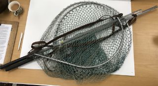 A collection of various fishing items to include two telescopic landing nets,