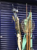 A bundle of various fishing rods and parts, three various landing nets,