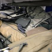 A large collection of various bankside fishing gear including sleeping bags,