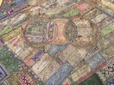 An Indian embroidered patchwork throw in silk,