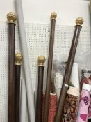 Seven curtain poles (one in two parts) and a bag of curtain rings