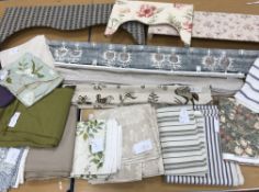 Three solid pelmets and three Roman blinds together with a quantity of unused furnishing remnants