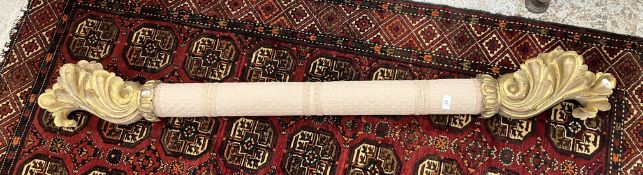 A 19th Century curtain pole with carved wood and gesso acanthus ends,