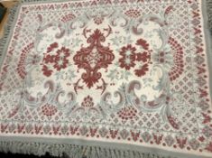 A wall rug in cream, sage and terracotta
