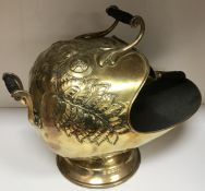 A Victorian embossed brass coal helmet w