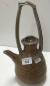 A salt glazed pottery teapot in the Arts