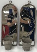 A small pair of garden mirrors with applied leaf decoration, each suspending a flower pot,