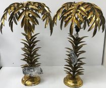 A pair of stylised palm tree table lamps, raised on a circular plinth base,