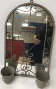 A modern garden mirror with triple plant pot and scrolling decoration, including hanging hook,
