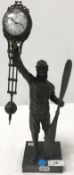 A mystery style clock held by a pilot holding a propellor, raised on a plinth base,