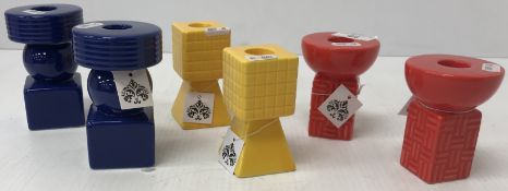 Three pairs of modern geometric candlesticks in primary colours,