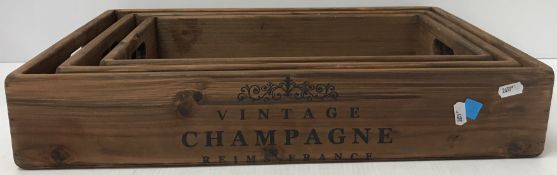 A set of three wooden twin-handled trays,