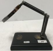 A desk mounted magnifying glass, bearing label inscribed 