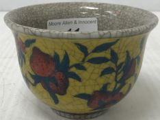 A Chinese tea bowl, the yellow ground decorated with floral sprays,