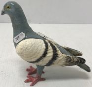 A painted cast metal figure of a pigeon,
