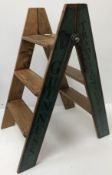 A pair of wooden steps inscribed 