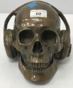 A bronze skull with headphones,