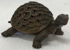An Oriental bronze tortoise ornament / censer, the shell with pierced decoration, 9 cm wide x 6.