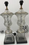 A pair of moulded glass table lamps in the form of Classical urns,