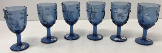 A set of six moulded blue glass wine glasses with face design, 16.