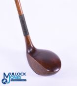 Large head left handed Brassie in dark stained persimmon stamped Ernest W le Fevre with attractively