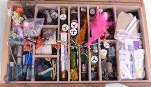 Comprehensive fly tying kit containing threads, silks, hooks, beads and wire, in a lift out tray