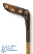 Travis Patent elongated wooden headed socket neck putter with 11x circular lead weights to the head,