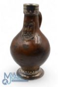 Vintage Face Wine Bottle. Made from stoneware with handle standing on a plated base with a metal