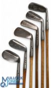 6x Maxwell golf irons incl a medium iron, a jigger, a 'Baxspin' mashie with diamond pattern and