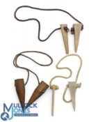 Two ivorine Patent Tooth Tees. Complete with second peg attached to string and a pair of carrot Tees