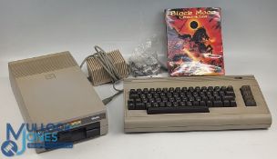 Commodore C65 Computer, with power adaptor and floppy disk 1541, black moon chronicles game, showing