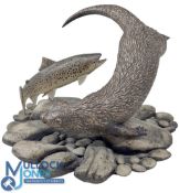 A Large Pottery Otter with Salmon Circling Sculpture. On a naturalistic pebble base signed N